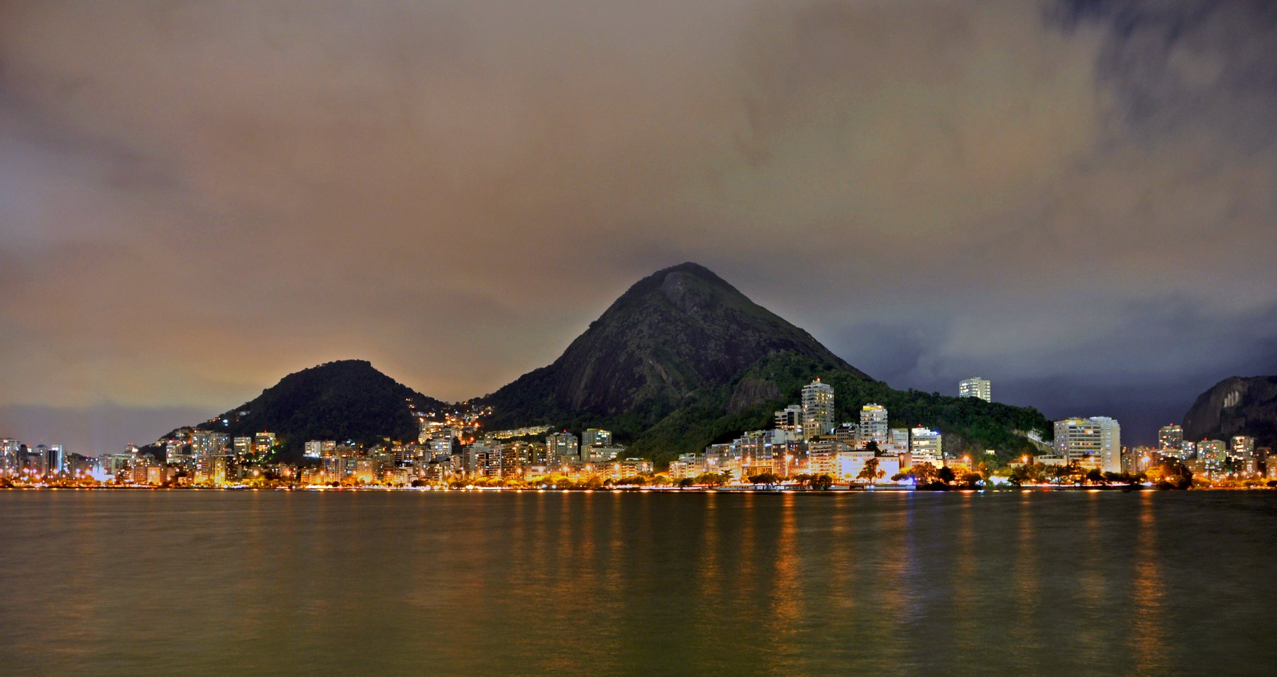 Lagoa Rodrigo de Freitas at night with the surrounding mountains and city lights
